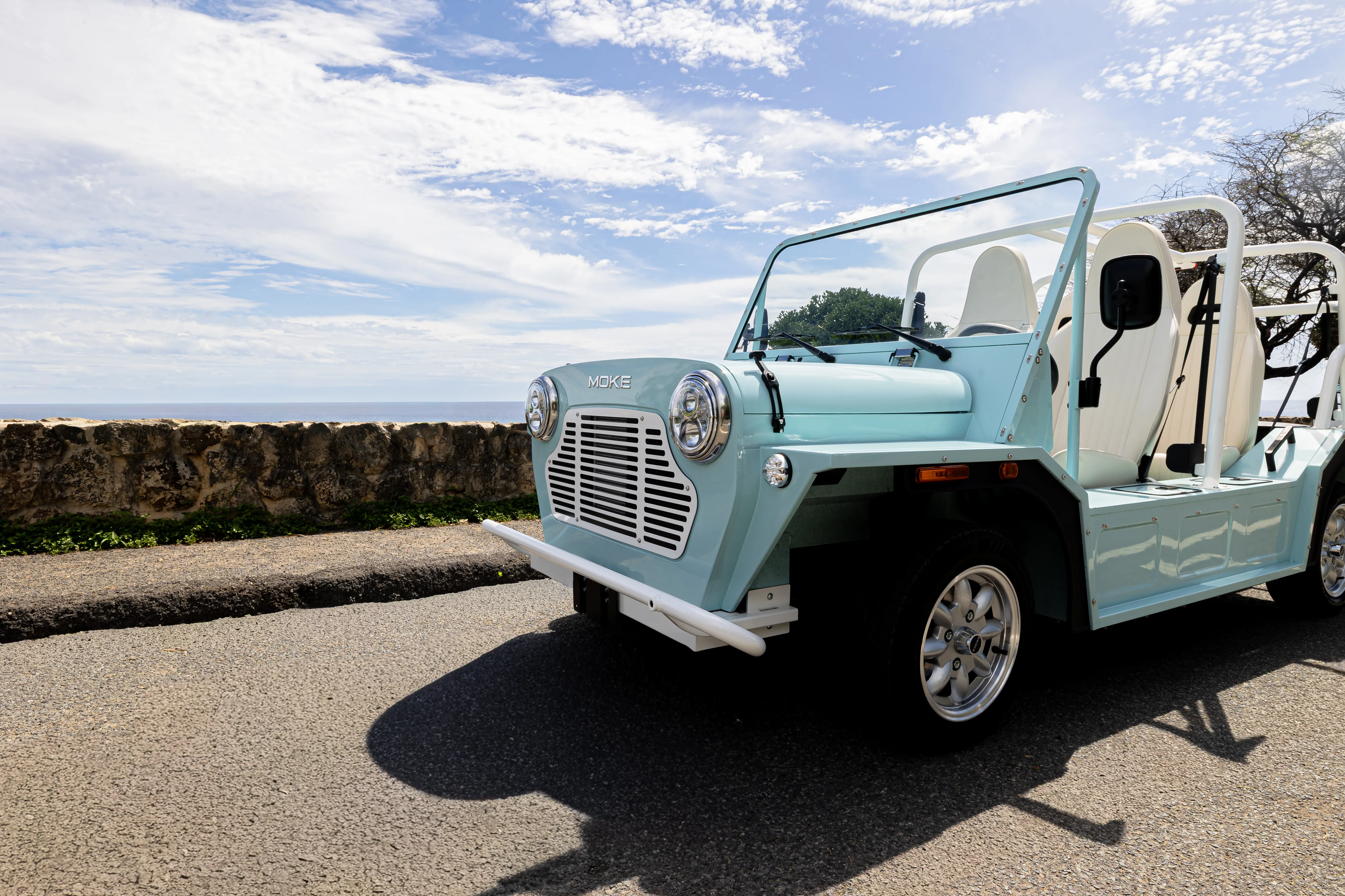 A Wave Blue Moke on the coast road near The Ritz-Carlton Residences, Waikiki Beach